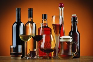 Bottles and glasses filled with various types of liquid Variety of different alcohols